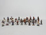 a lot of figurines that are on a white surface