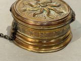 a gold box with a chain around it on a table