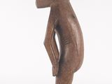 an image of a wooden statue of a person with a hat on