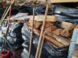a large pile of wood in a warehouse next to a pile of other wood