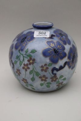 a small blue vase with flowers on it on a white surface