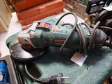 a corded tool sitting on top of a green table