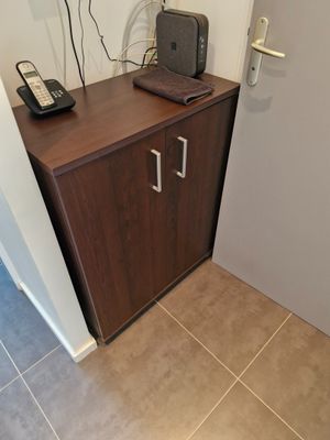 a small cabinet with a phone on top of it