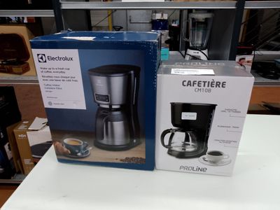 two boxes of coffee makers on a table in a store