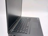a black laptop with a blue keyboard on a white surface