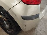 a close up of a car ' s rear end with a tire