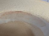 a close up of a hat with a hole in it