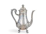 une théière ancienne en argent, munie d'une anse et posée sur un socle