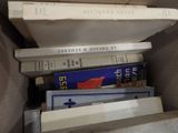 a lot of books in a box on the floor