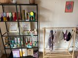 a room with a shelf and a rack with ties on it