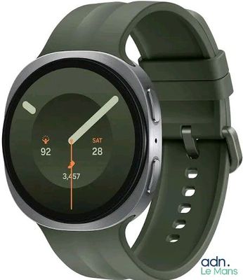 a smart watch with a green band on the wrist