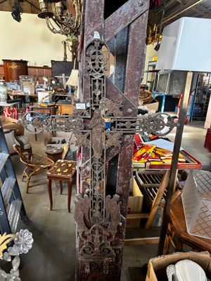 une grande croix au milieu d'une pièce remplie de meubles
