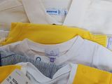 a lot of baby clothes that are sitting on a table