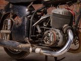 a motorcycle that is parked in front of a brick wall
