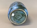 a close up of a blue vase with a tag on it