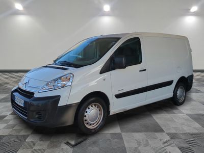 the white van is parked on a checkered floor in a room