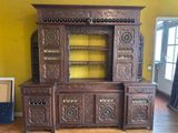 a large wooden cabinet with a mirror on top of it