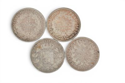 six different british coins are arranged in a row on a white surface