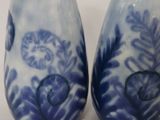 two blue and white vases sitting on a table