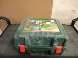 a green tool box sitting on top of a black table