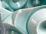 a close up of a blue bowl with a design on it