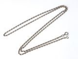 a close up of a chain on a white surface with a white background