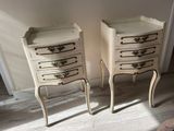 two white chests with drawers on them in a room