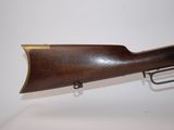 a rifle with a wooden barrel on a white background