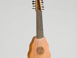 une image représentant un instrument en bois doté d'un long manche et d'un long manche
