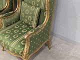 two green chairs sitting next to each other in a room