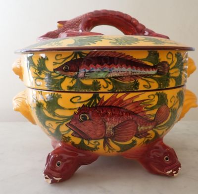 a yellow and red bowl with a fish design on it