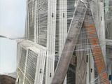a pile of windows on a pallet on the roof of a building