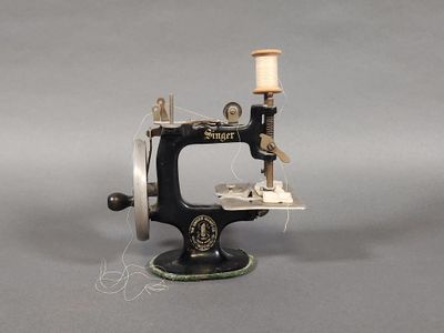 a small sewing machine that is sitting on a table