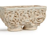 a stone planter with a design on it