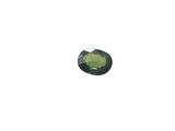 a close up of a green stone on a white surface