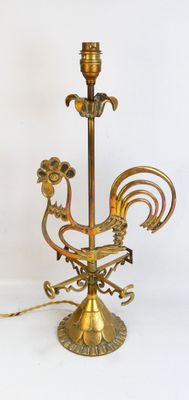 a gold colored candle holder with a rooster on it