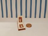 a small book sitting on a table next to a penny
