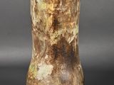 a vase that is sitting on a table with a gray background