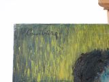 a painting on a easel with a painting of a cow