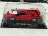 a red toy car in a clear case on a table