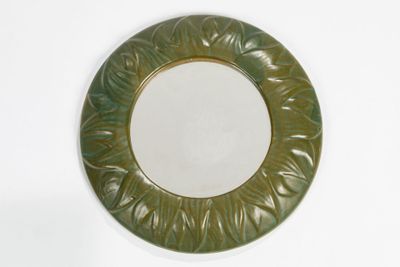a green plate with a circular design on it