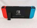 two nintendo switch controllers sitting side by side on a table