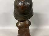 statue of a woman with a hat on top of her head