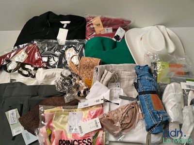 a pile of clothes and other items on a shelf