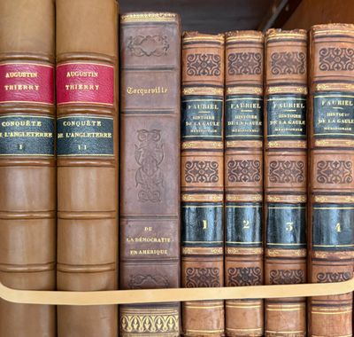 many books that are on a shelf in a library