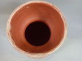 a brown vase sitting on a table with a white background