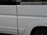 a white van that is parked on the side of the street