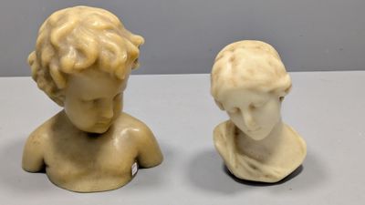 pair of marble busts of a boy and a girl