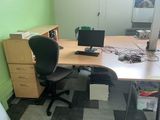 a desk with a chair and a computer on it