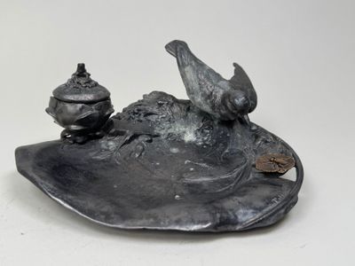 two birds sitting on top of a plate on a table
